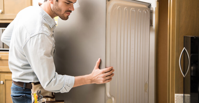 Technician installing American fridge freezer